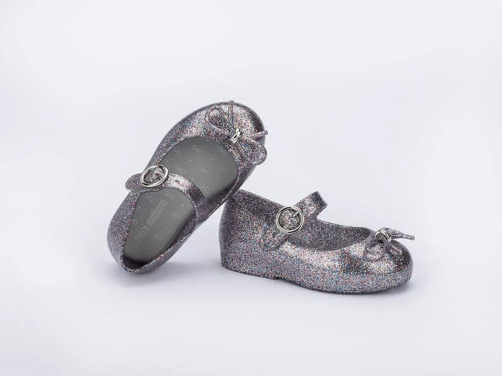 Certainly! Heres an optimized title for your product:

Adorable Baby Girls Silver Glitter Sandals with Bow Applique - Mini Melissa Sweet Love