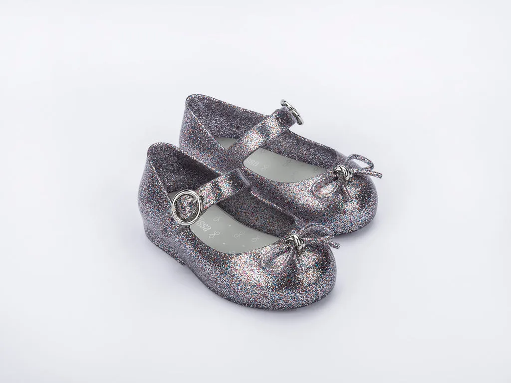 Certainly! Heres an optimized title for your product:

Adorable Baby Girls Silver Glitter Sandals with Bow Applique - Mini Melissa Sweet Love